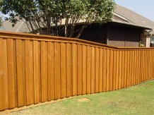 This is an image of a board on board fence with a top decorative board.