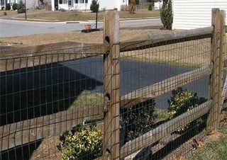 This is an image of another split rail fence. This has wire mesh on the inside of the fence.